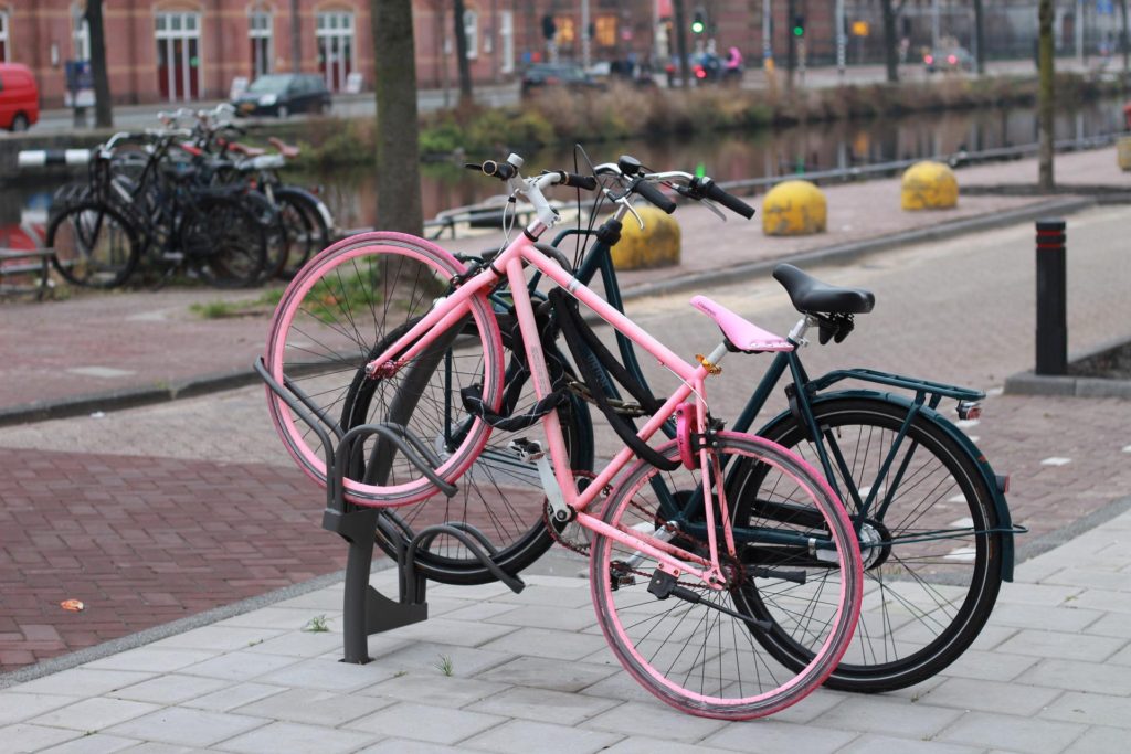 Image of a small pink bike next to a bigger black bike