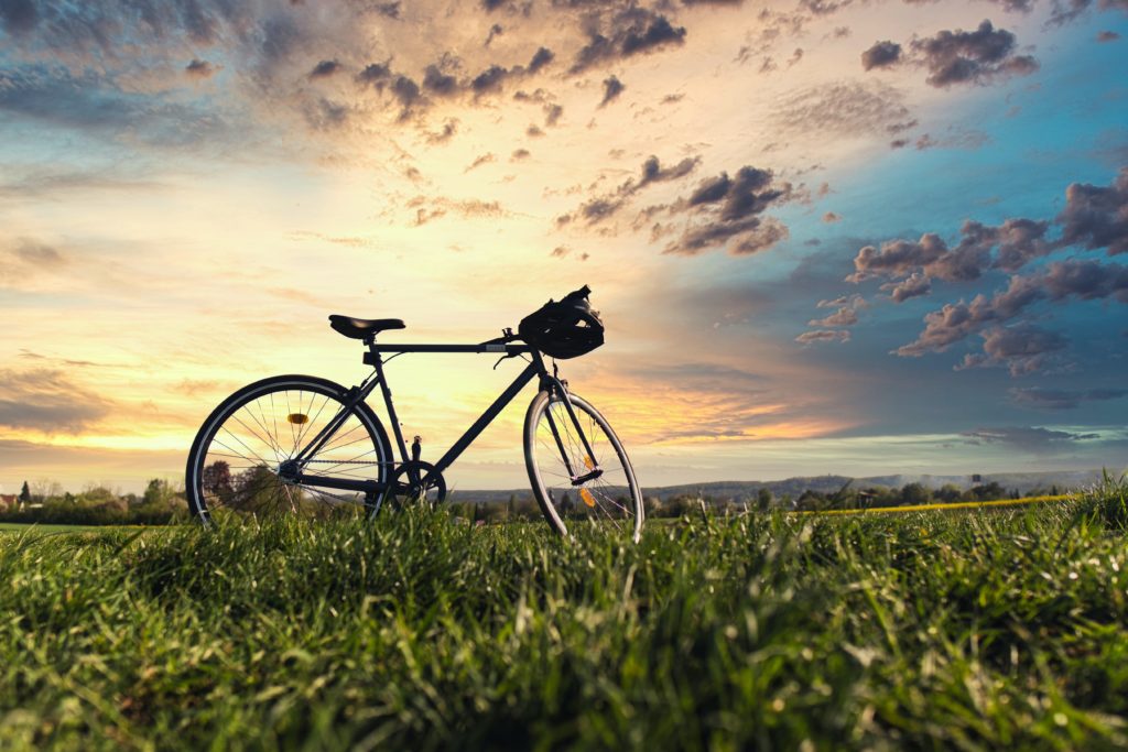 Image of a bike in a field at sunset